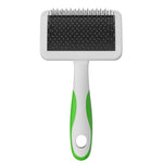 Pet grooming brush with black bristle side and green handle on a white background